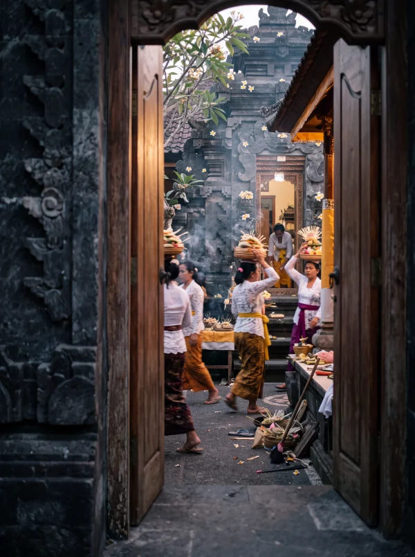 Through the gate: offerings carried into a courtyard mid-ceremony