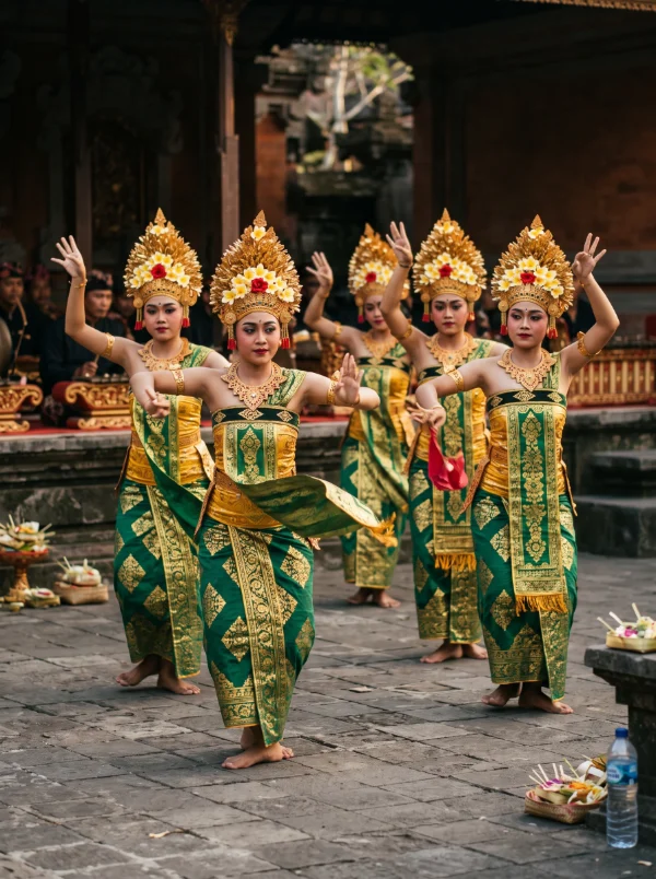 Legong dancers mid-movement in a temple courtyard